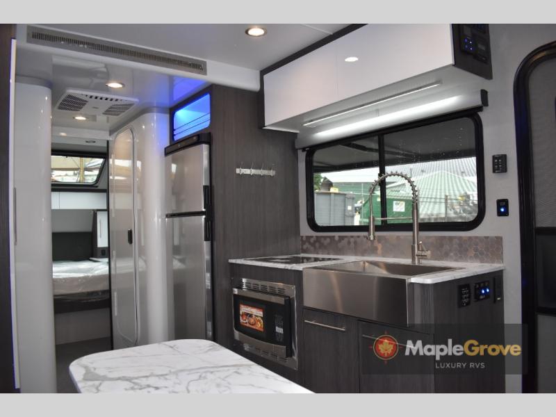 inTech RV O-V-R Navigate interior view of the kitchen and front bedroom